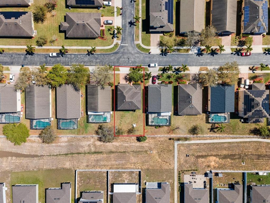 754 Andalusia Loop Davenport, FL 33837 - Photo 27 of 28 a kitchen area with granite countertop a sink and a stove