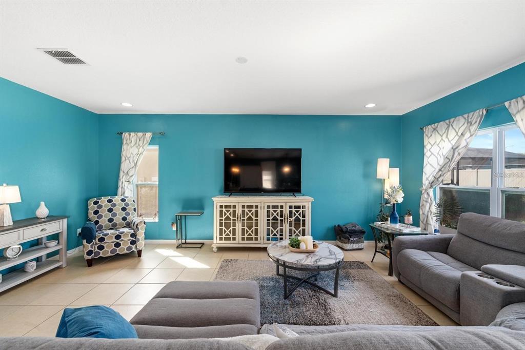 754 Andalusia Loop Davenport, FL 33837 - Photo 6 of 28 a living room with furniture and a flat screen tv