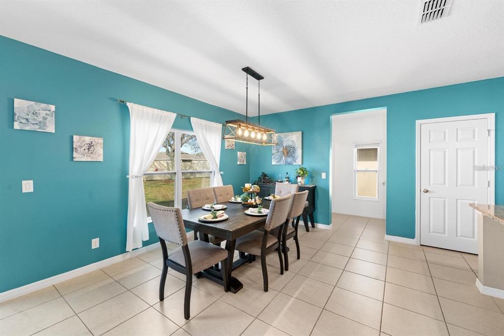754 Andalusia Loop Davenport, FL 33837 - Photo 8 of 28 a dining room with furniture and window