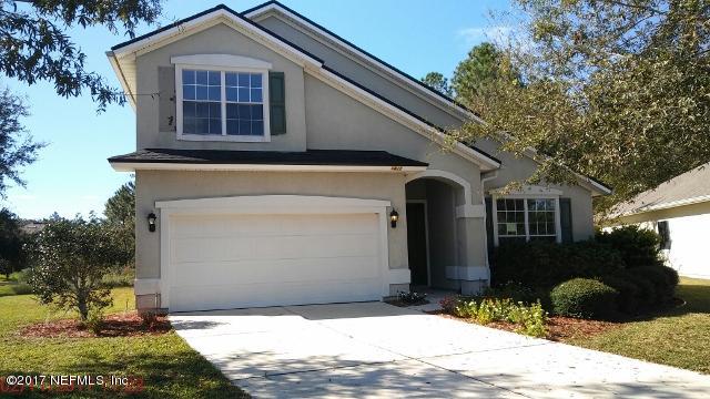 3421 South Saxxon Road St. Augustine, FL 32092 - Photo 1 of 13 a front view of a house with a yard