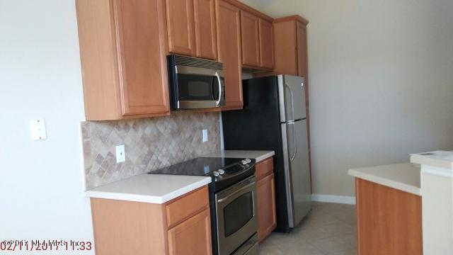 3421 South Saxxon Road St. Augustine, FL 32092 - Photo 3 of 13 a kitchen with a stove microwave and sink