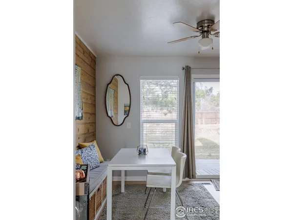 a view of a room with a table and chairs