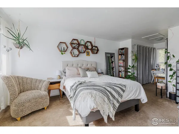 a bedroom with a bed and a couch