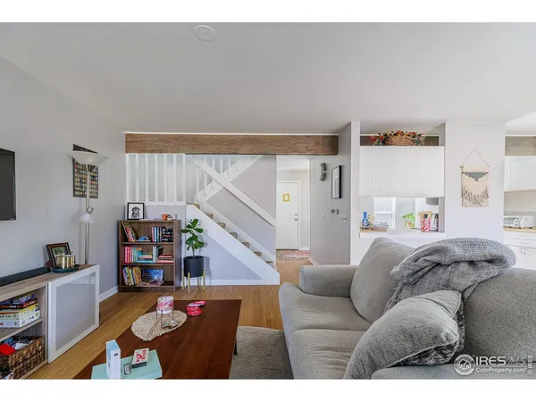 a living room with furniture and a book shelf