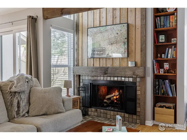 a living room with furniture a window and a fireplace