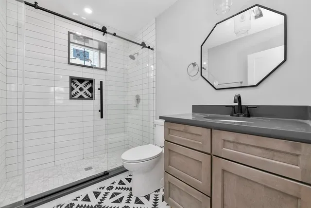 a bathroom with a toilet sink and mirror