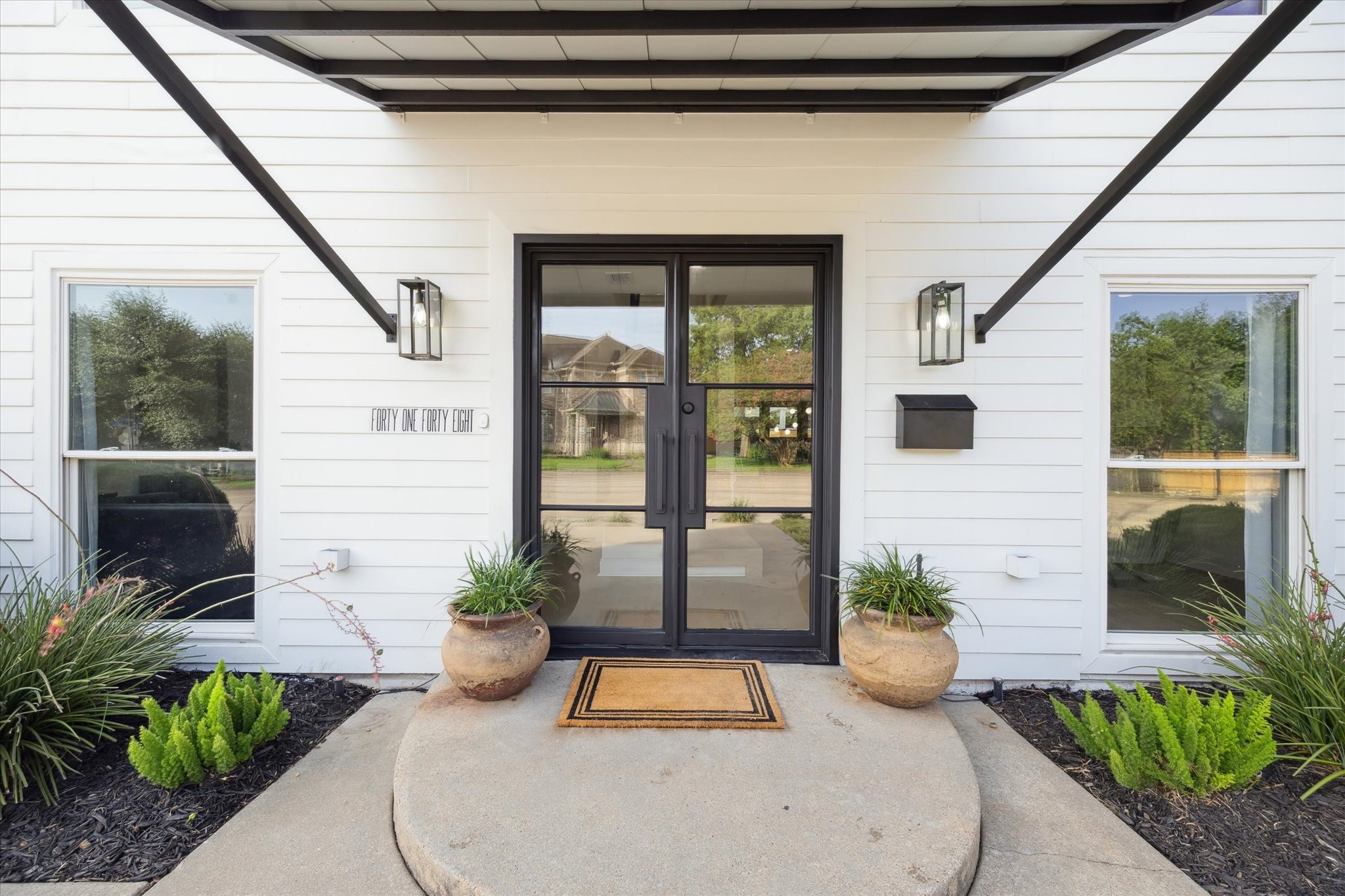 a potted plant sitting in front of a door