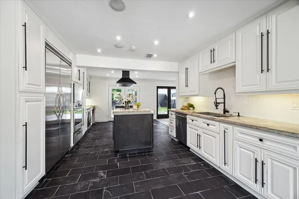 a kitchen with sink cabinets and window