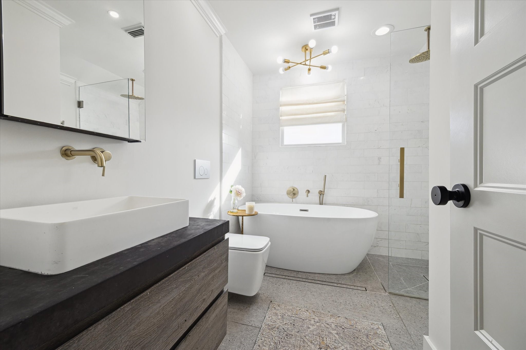 4148 Bissonnet Street West University Place, TX 77005 - Photo 20 of 39 a bathroom with a double vanity sink a toilet a mirror and bathtub