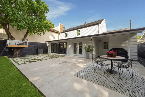 a view of a patio with table and chairs a barbeque with wooden fence