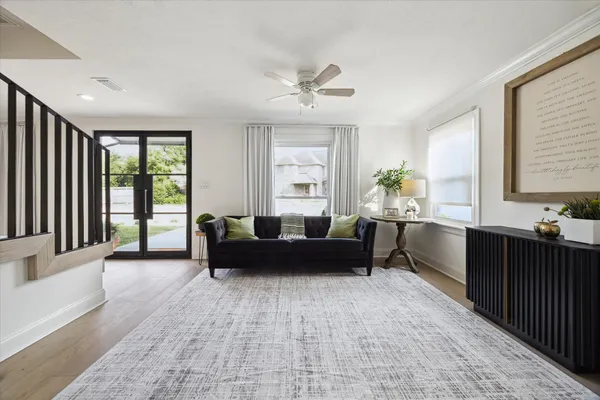 a living room with furniture and large windows