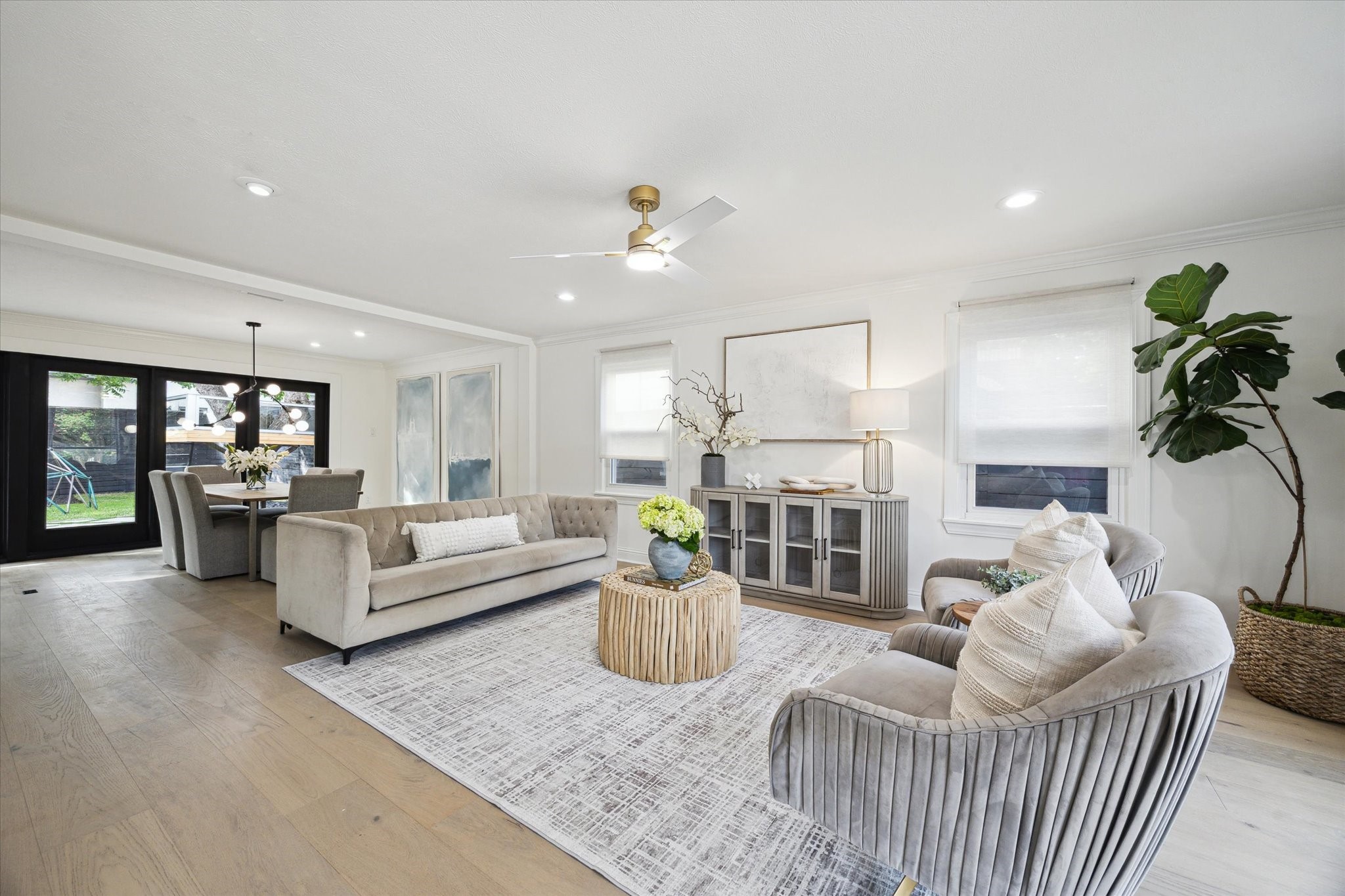 4148 Bissonnet Street West University Place, TX 77005 - Photo 10 of 39 a living room with furniture a chandelier and a dining room