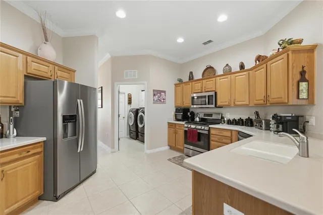 a kitchen with granite countertop a refrigerator and a sink