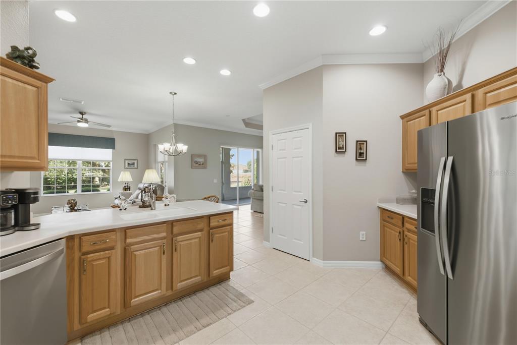 8821 Southwest 82nd Court Road Ocala, FL 34481 - Photo 12 of 32 a kitchen with sink cabinets and refrigerator