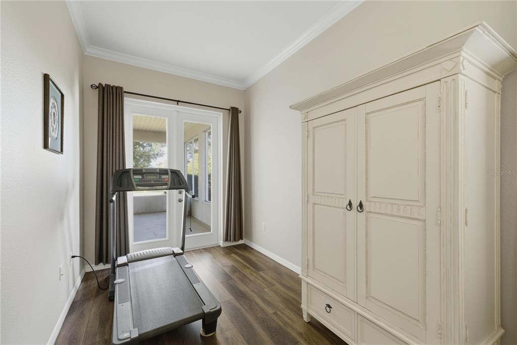 8821 Southwest 82nd Court Road Ocala, FL 34481 - Photo 14 of 32 a view of a utility room with closet empty shelves and wooden floor