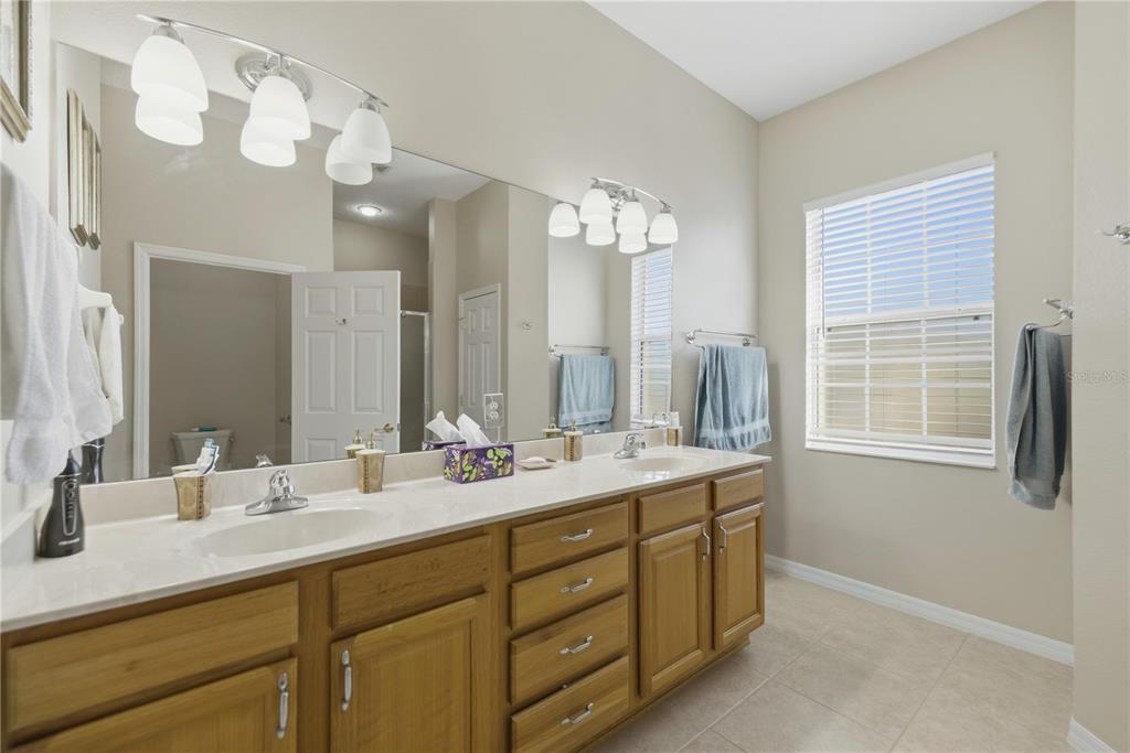 8821 Southwest 82nd Court Road Ocala, FL 34481 - Photo 16 of 32 a bathroom with a double vanity sink mirror and double
