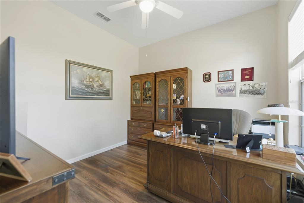 8821 Southwest 82nd Court Road Ocala, FL 34481 - Photo 18 of 32 a view of a workspace with furniture and chandelier