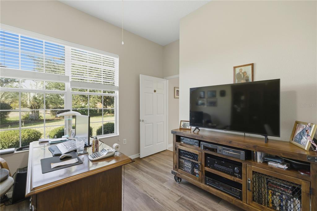 8821 Southwest 82nd Court Road Ocala, FL 34481 - Photo 19 of 32 a room with furniture and flat screen tv