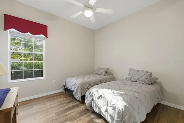 a bed room with two bed and a window