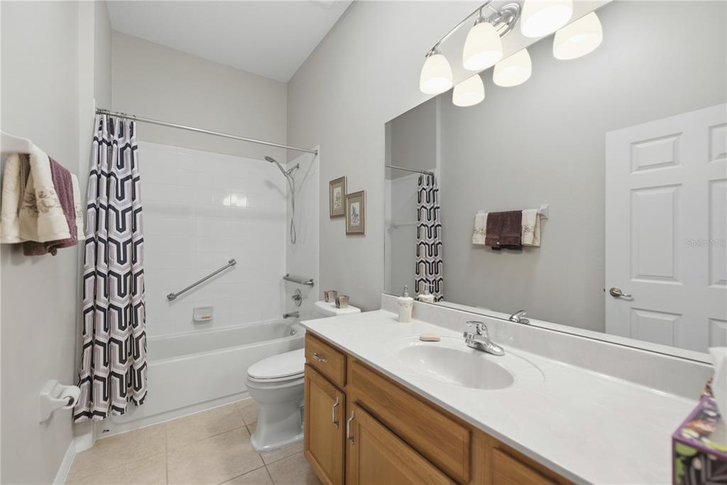 8821 Southwest 82nd Court Road Ocala, FL 34481 - Photo 22 of 32 a bathroom with a sink a toilet and a large mirror