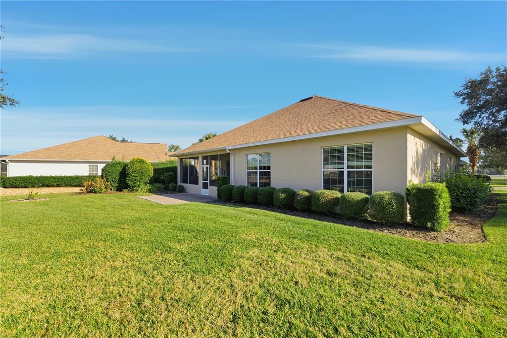 8821 Southwest 82nd Court Road Ocala, FL 34481 - Photo 29 of 32 a front view of a house with garden