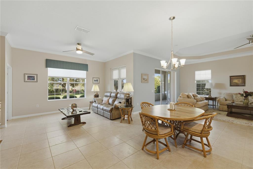8821 Southwest 82nd Court Road Ocala, FL 34481 - Photo 9 of 32 a living room with furniture and a chandelier