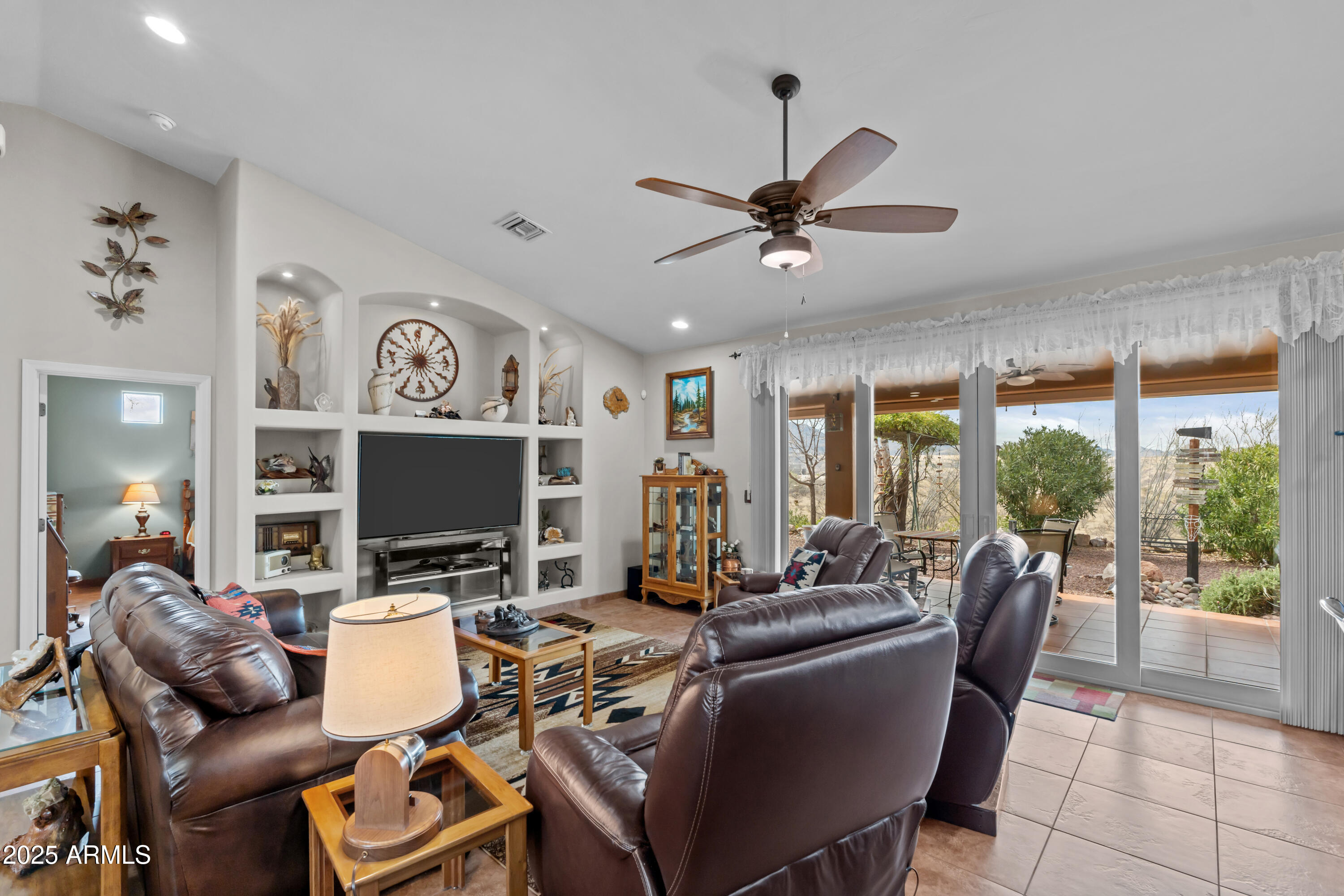 608 Paseo Reforma Rio Rico, AZ 85648 - Photo 13 of 50 a living room with furniture a flat screen tv and a large window