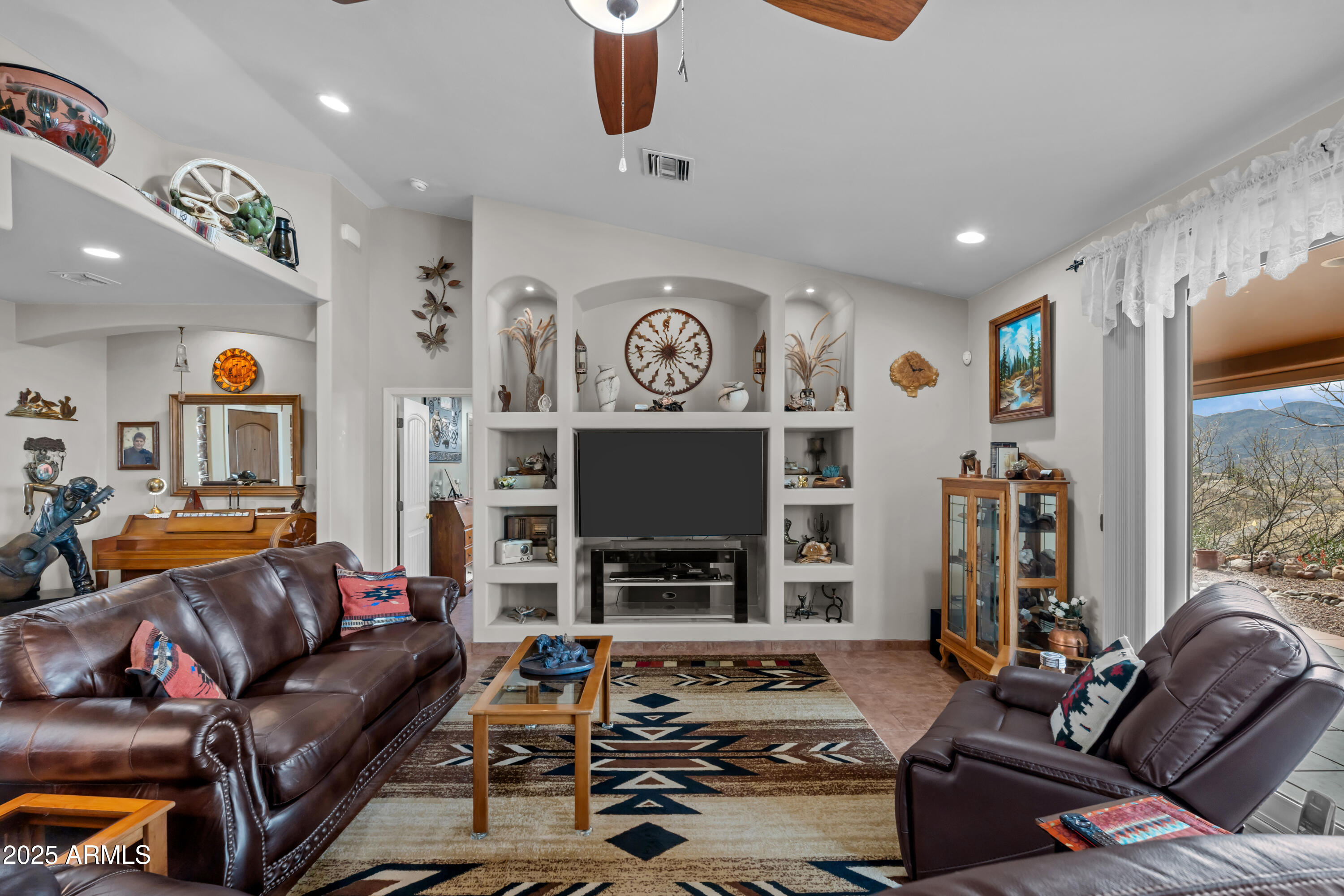 608 Paseo Reforma Rio Rico, AZ 85648 - Photo 14 of 50 a living room with furniture and a fireplace