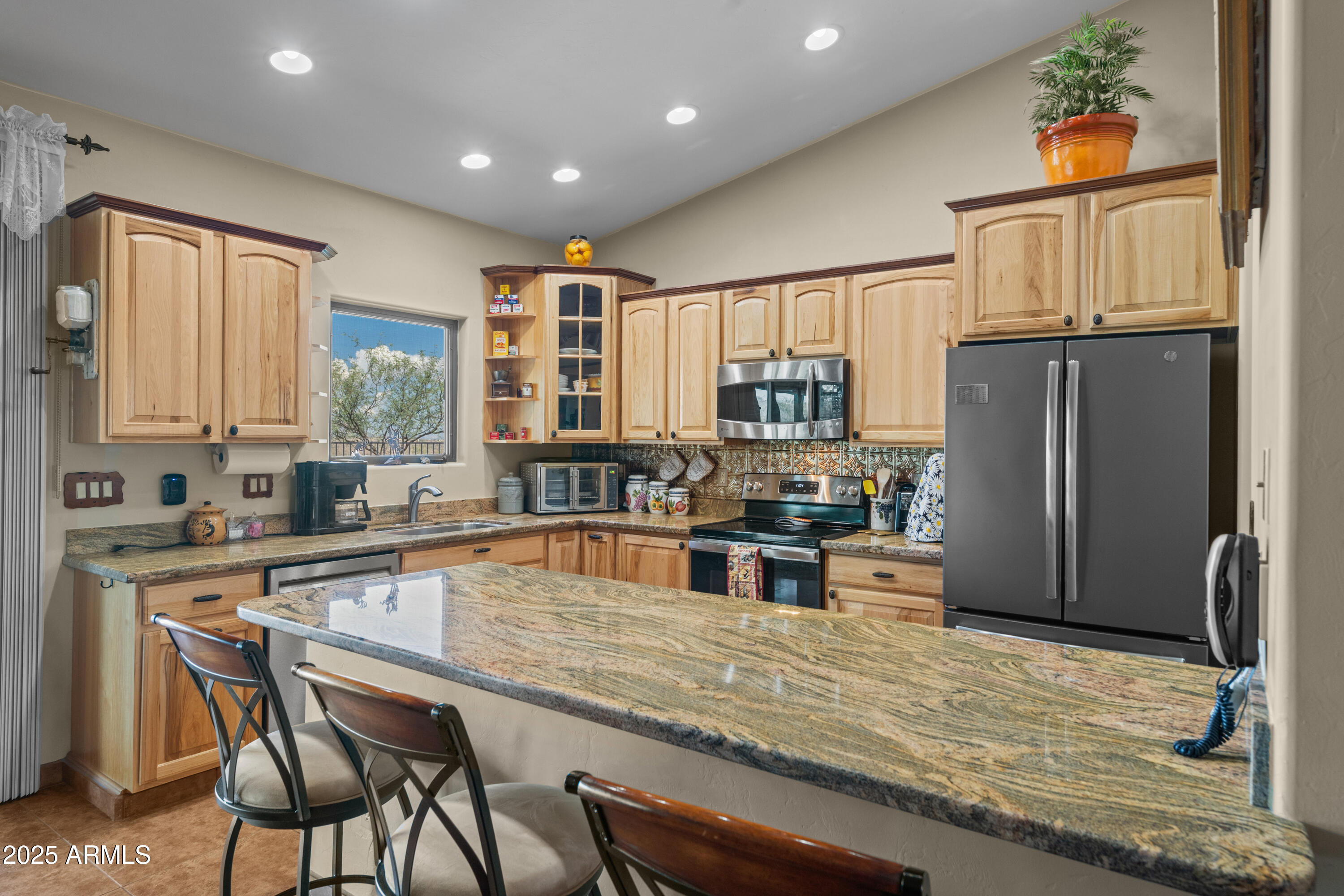 608 Paseo Reforma Rio Rico, AZ 85648 - Photo 15 of 50 a kitchen with stainless steel appliances granite countertop a refrigerator and a stove top oven