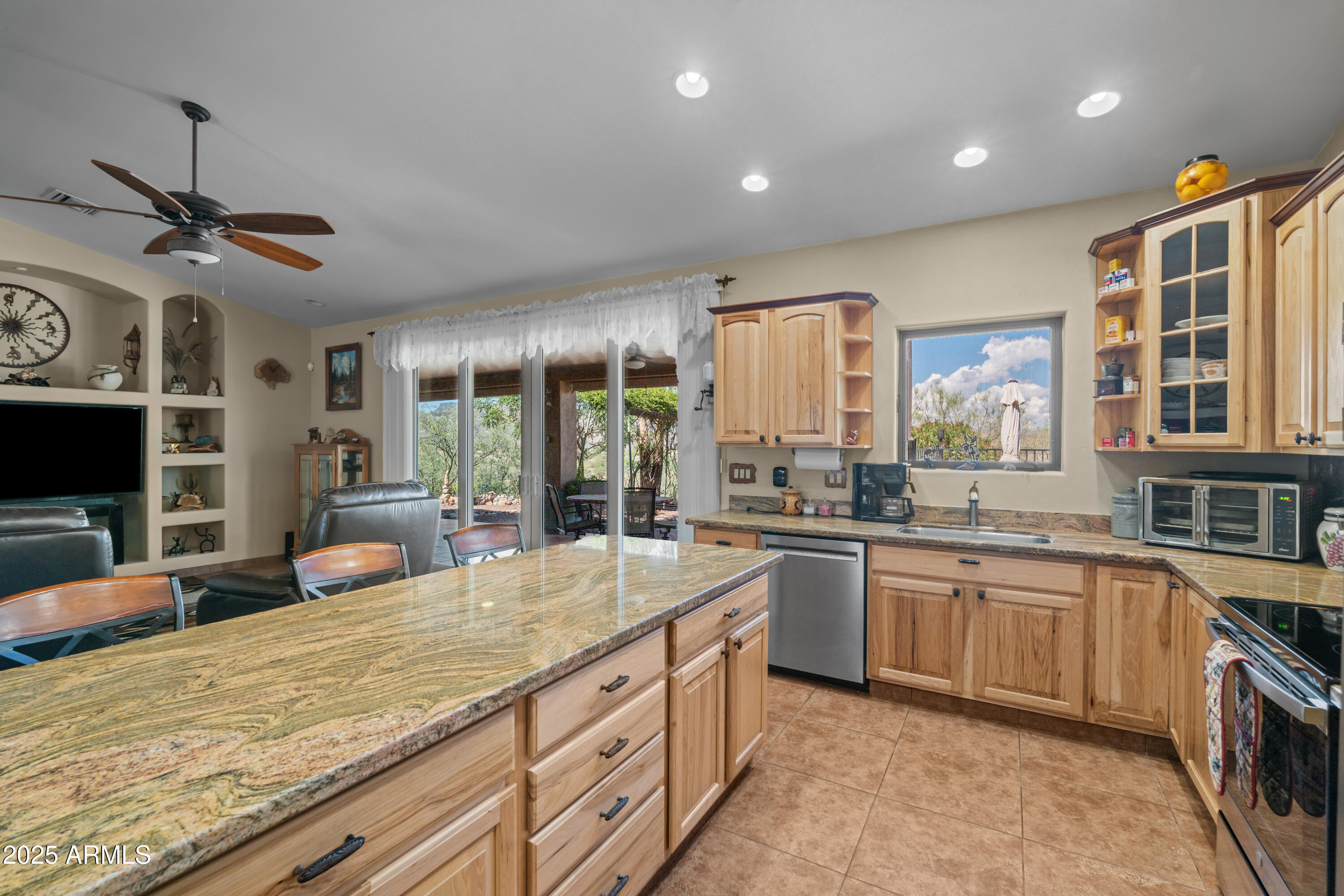 608 Paseo Reforma Rio Rico, AZ 85648 - Photo 16 of 50 a large kitchen with kitchen island a large counter space a sink appliances and cabinets