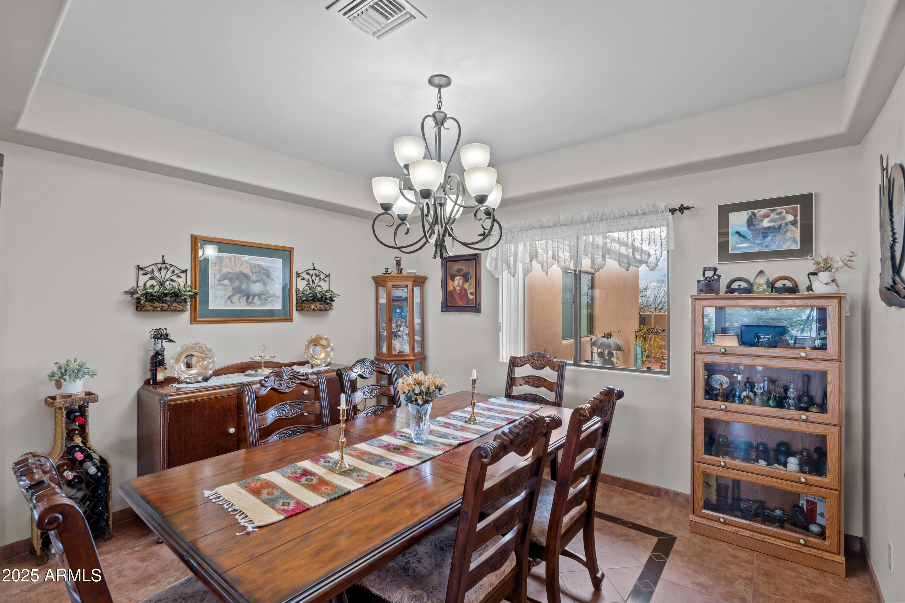 608 Paseo Reforma Rio Rico, AZ 85648 - Photo 17 of 50 a view of a dining room with furniture a chandelier and wooden floor