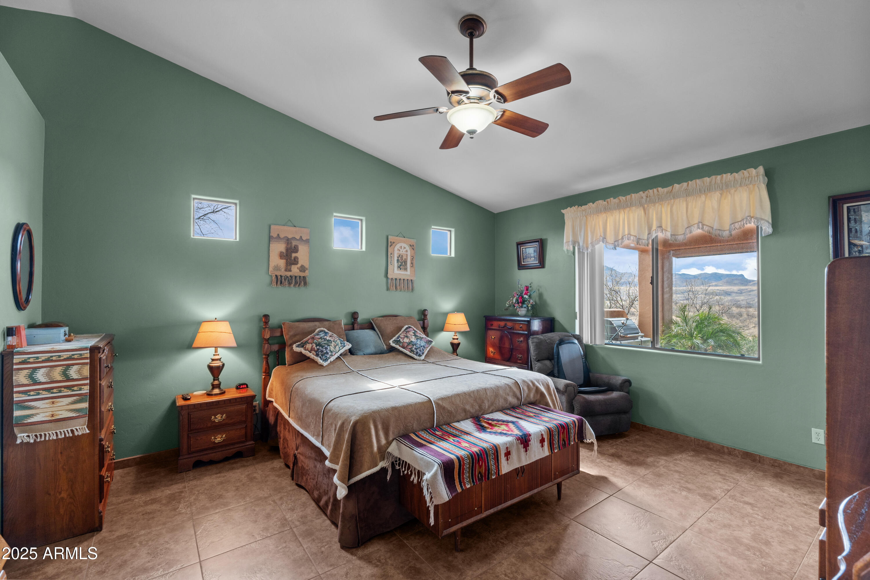 608 Paseo Reforma Rio Rico, AZ 85648 - Photo 18 of 50 a bedroom with a bed and a chandelier