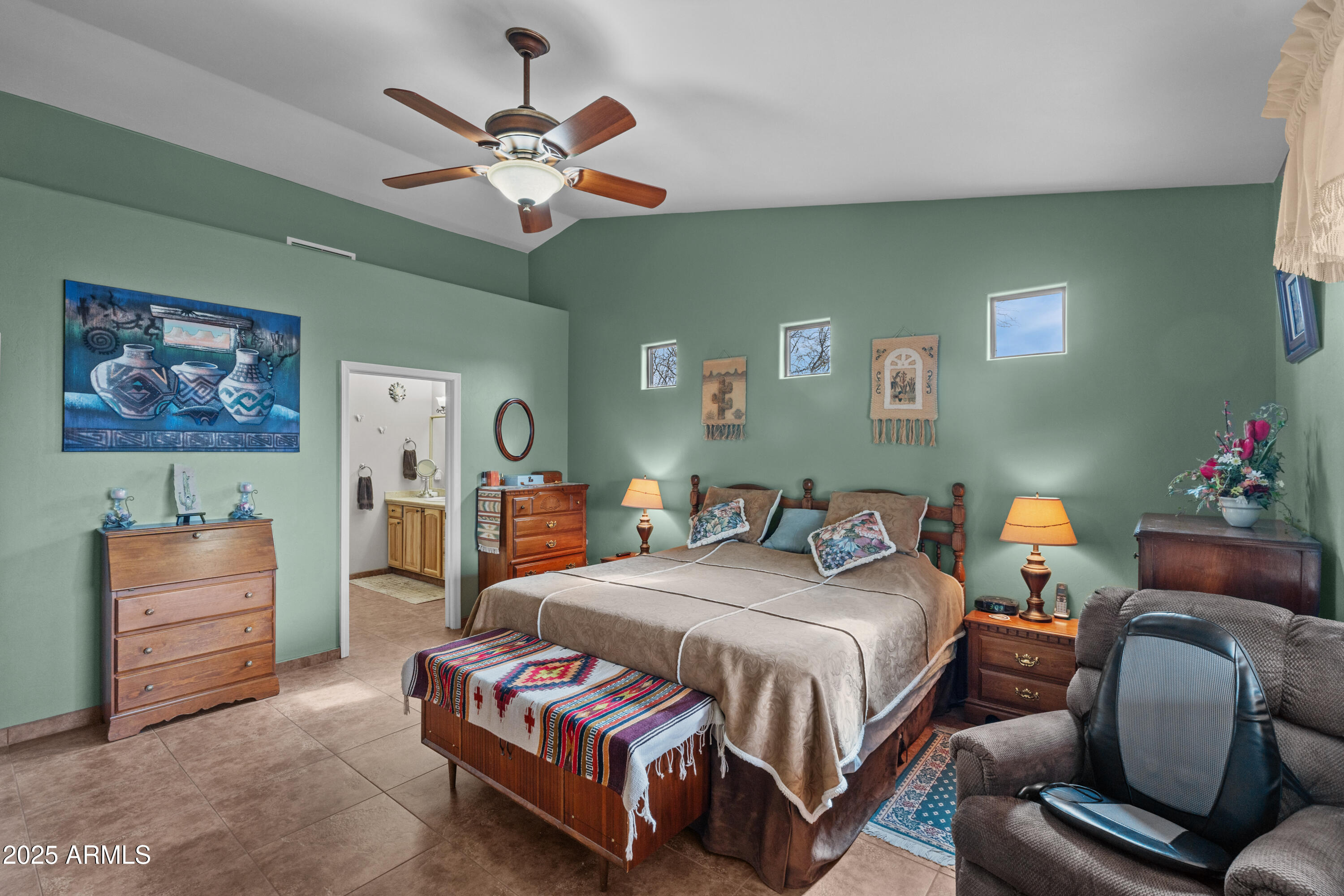 608 Paseo Reforma Rio Rico, AZ 85648 - Photo 20 of 50 a bedroom with a bed and a chandelier