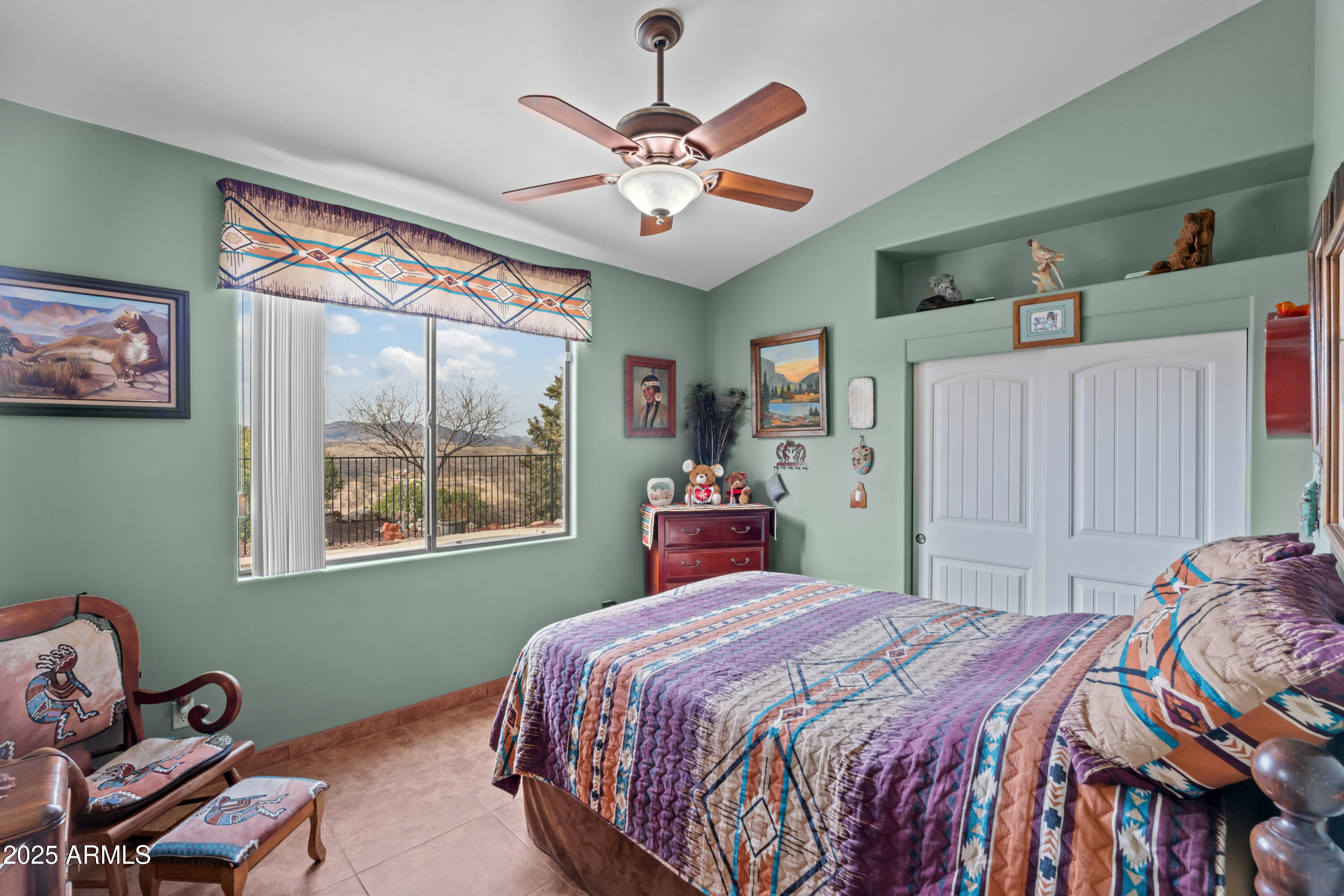 608 Paseo Reforma Rio Rico, AZ 85648 - Photo 25 of 50 a bedroom with a bed and a chandelier