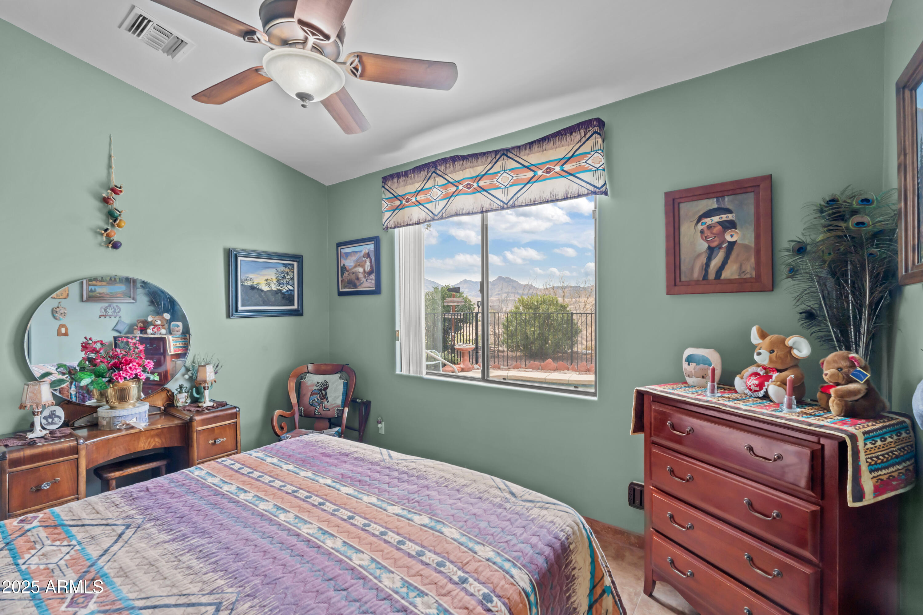 608 Paseo Reforma Rio Rico, AZ 85648 - Photo 26 of 50 a bedroom with a bed and a chandelier
