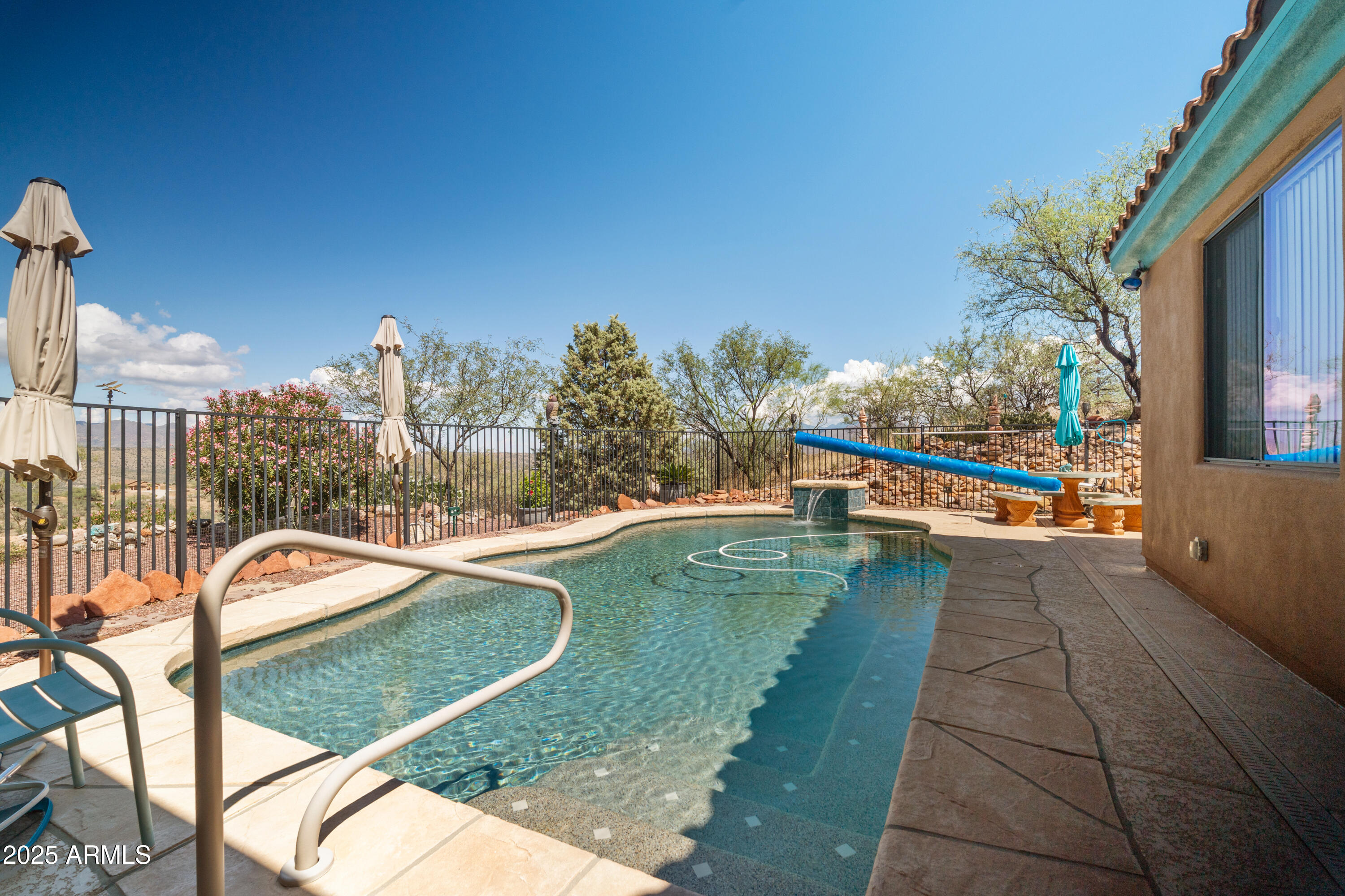 608 Paseo Reforma Rio Rico, AZ 85648 - Photo 34 of 50 a view of a swimming pool with a lounge chairs
