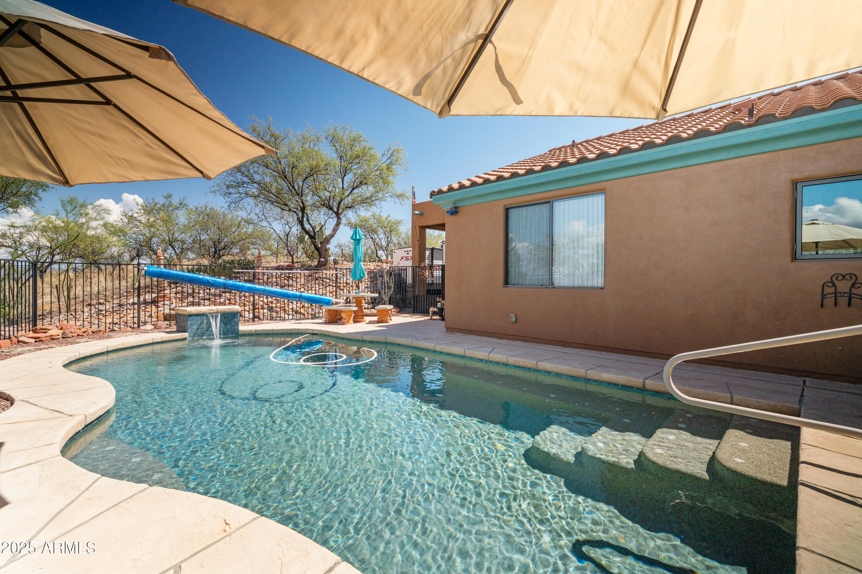 608 Paseo Reforma Rio Rico, AZ 85648 - Photo 35 of 50 a backyard of a house with wooden floor and outdoor seating