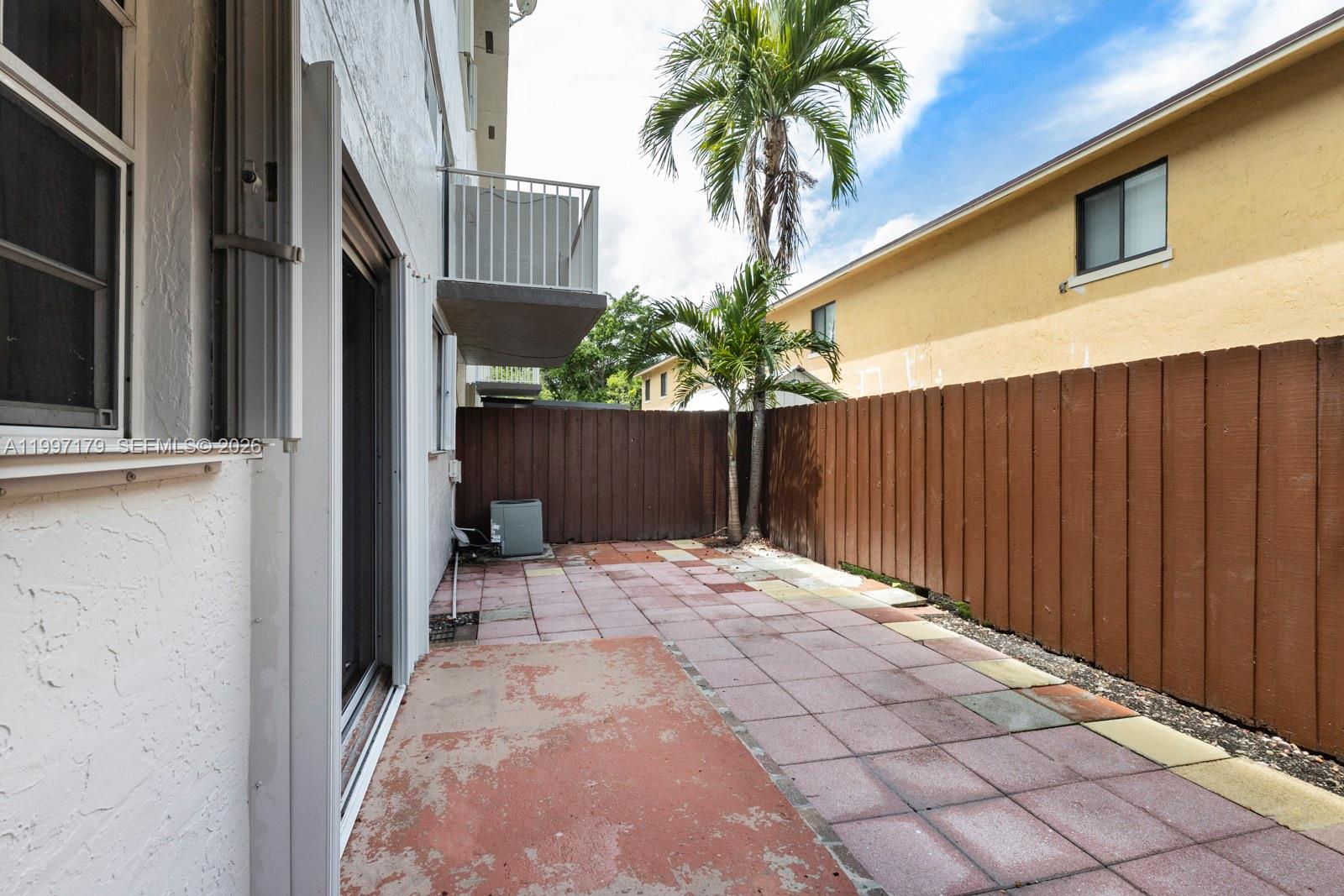 7510 Southwest 152nd Avenue, Unit C104 Miami, FL 33193 - Photo 12 of 14 a backyard of a house with palm trees