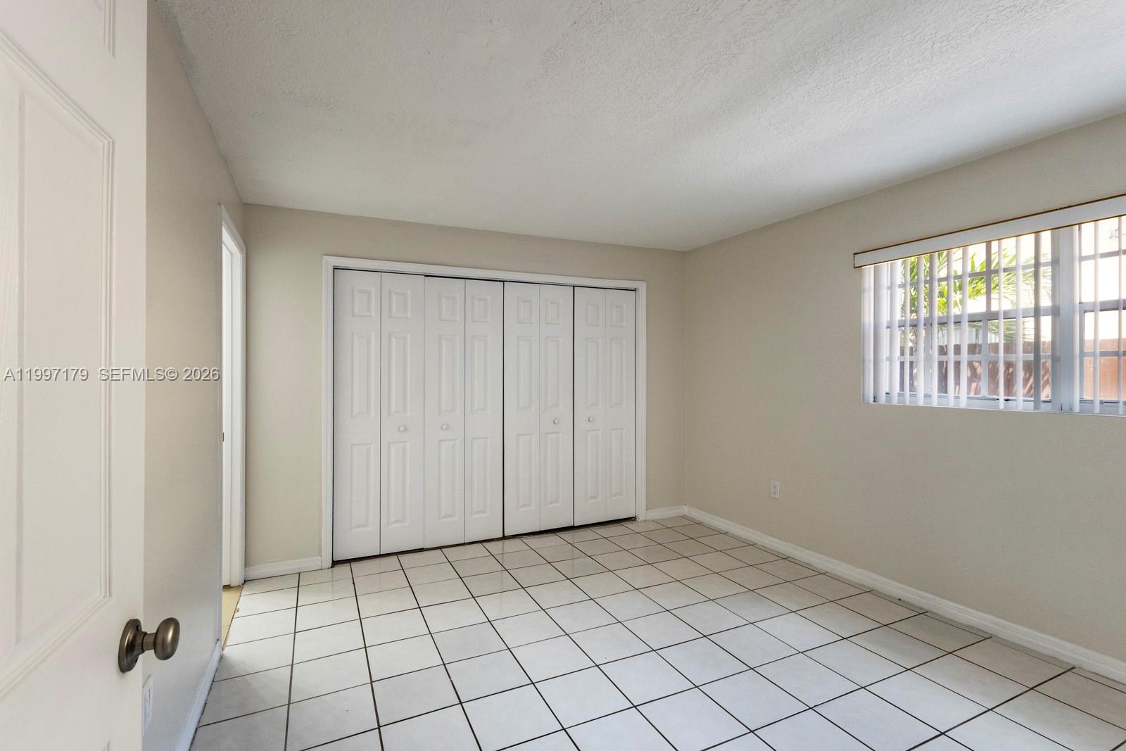 7510 Southwest 152nd Avenue, Unit C104 Miami, FL 33193 - Photo 7 of 14 a view of an empty room and window