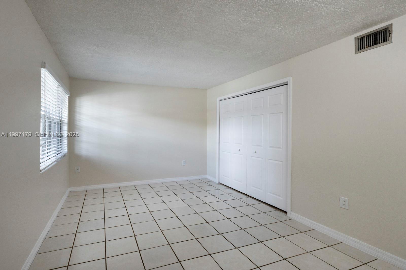 7510 Southwest 152nd Avenue, Unit C104 Miami, FL 33193 - Photo 9 of 14 a view of an empty room and window