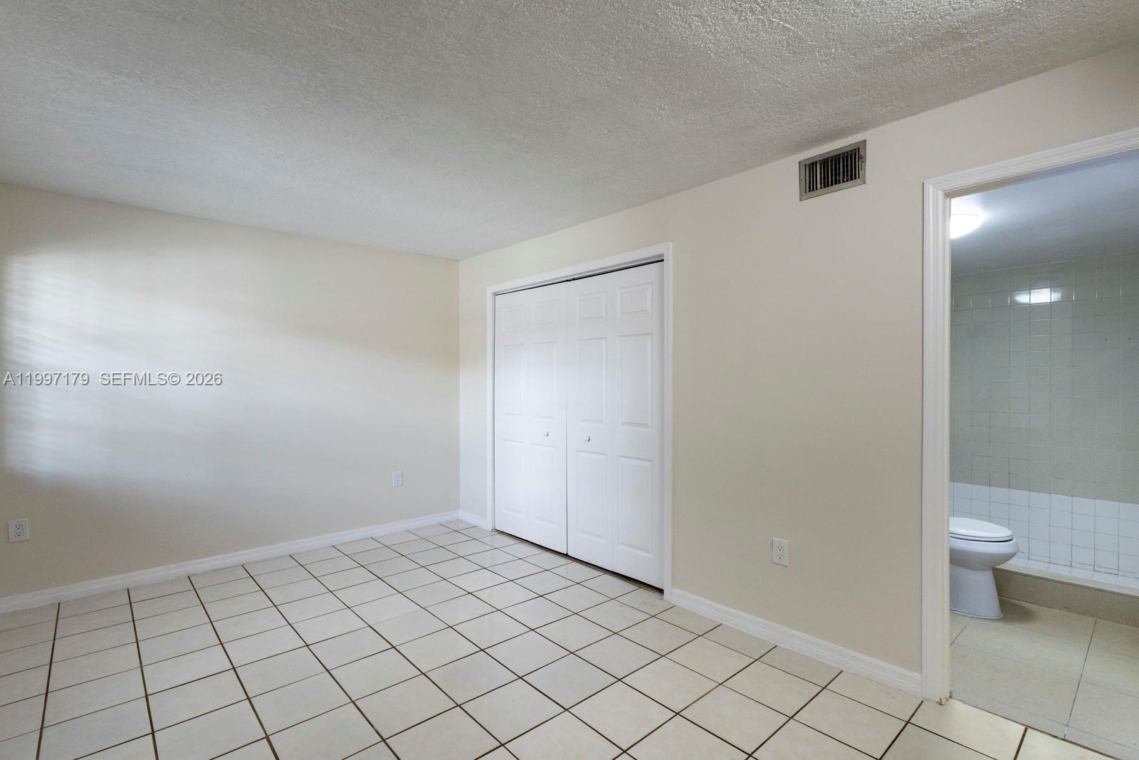 7510 Southwest 152nd Avenue, Unit C104 Miami, FL 33193 - Photo 10 of 14 a view of an empty room and window