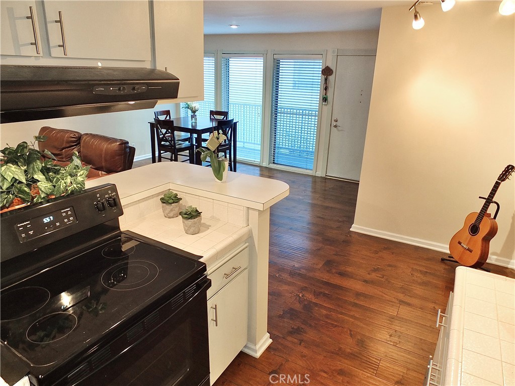 1770 Ximeno Avenue, Unit 314 Long Beach, CA 90815 - Photo 11 of 37 a kitchen with a stove and a refrigerator