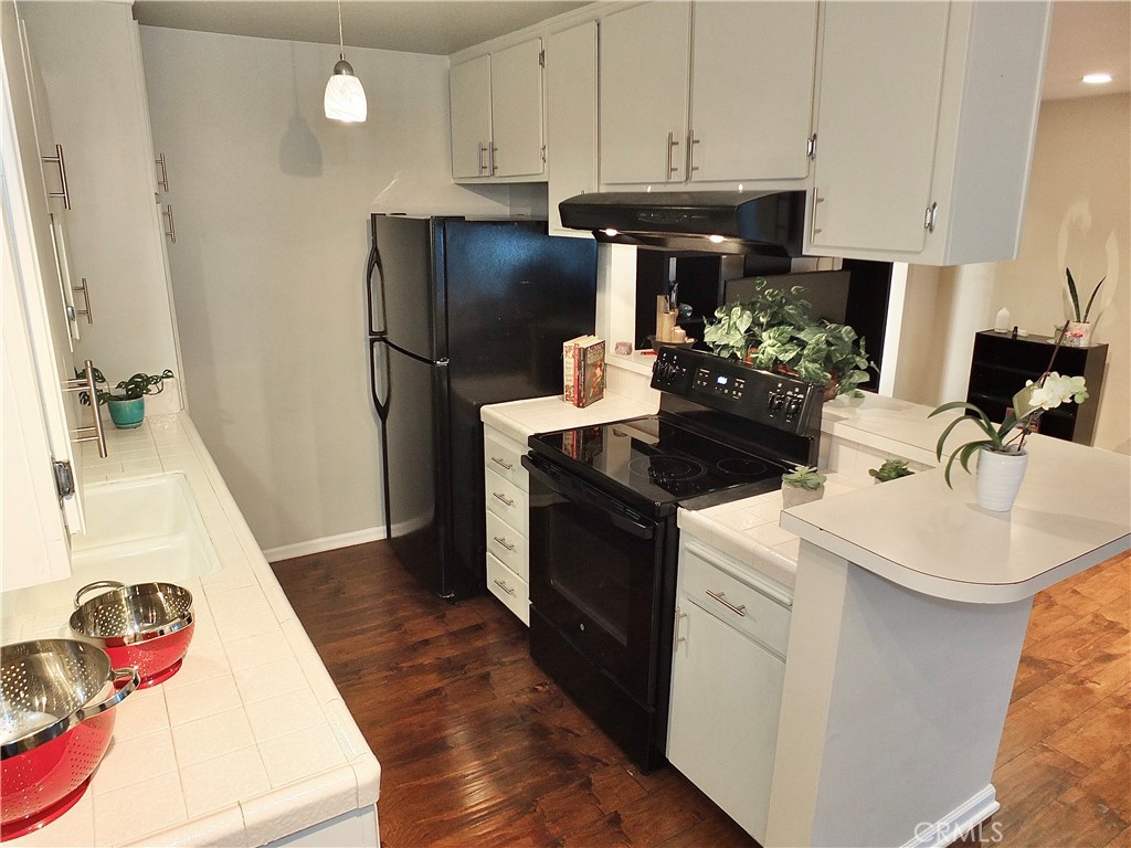 1770 Ximeno Avenue, Unit 314 Long Beach, CA 90815 - Photo 12 of 37 a kitchen with a sink and refrigerator