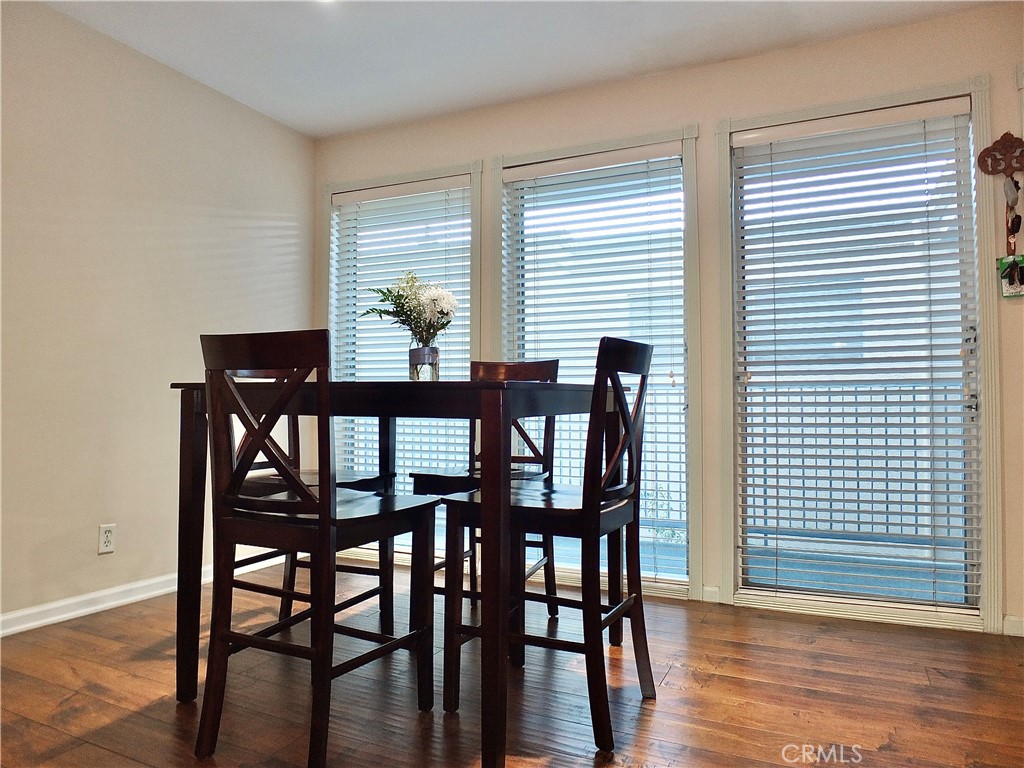 1770 Ximeno Avenue, Unit 314 Long Beach, CA 90815 - Photo 15 of 37 a dining room with furniture and wooden floor