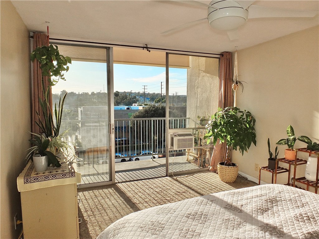 1770 Ximeno Avenue, Unit 314 Long Beach, CA 90815 - Photo 17 of 37 a bedroom with a bed and large window with outer view