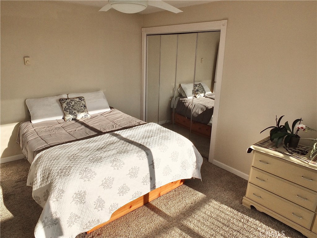 1770 Ximeno Avenue, Unit 314 Long Beach, CA 90815 - Photo 18 of 37 a bedroom with a bed and a mirror