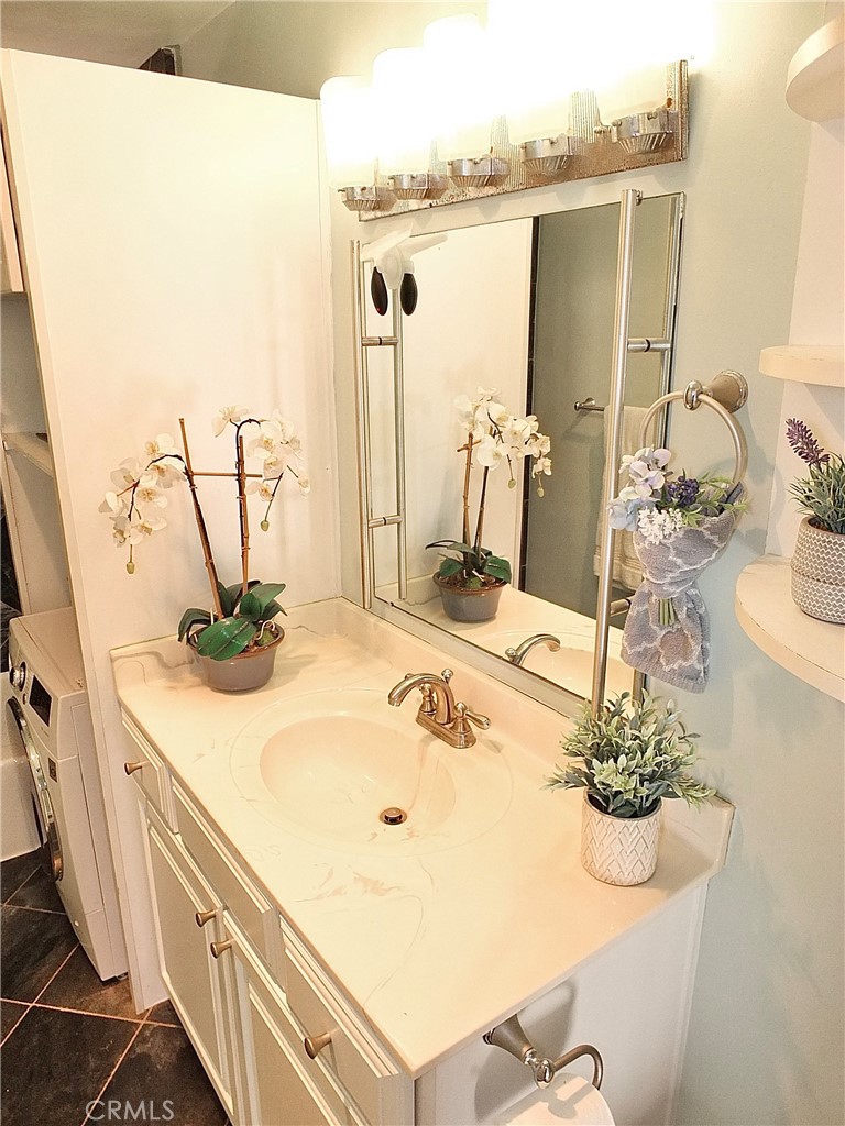 1770 Ximeno Avenue, Unit 314 Long Beach, CA 90815 - Photo 19 of 37 a bathroom with a sink and a mirror