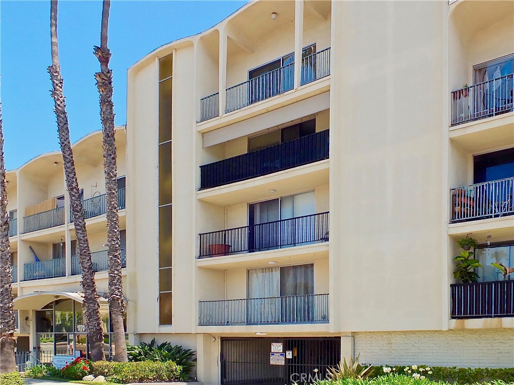 1770 Ximeno Avenue, Unit 314 Long Beach, CA 90815 - Photo 2 of 37 a front view of a building with glass windows and door