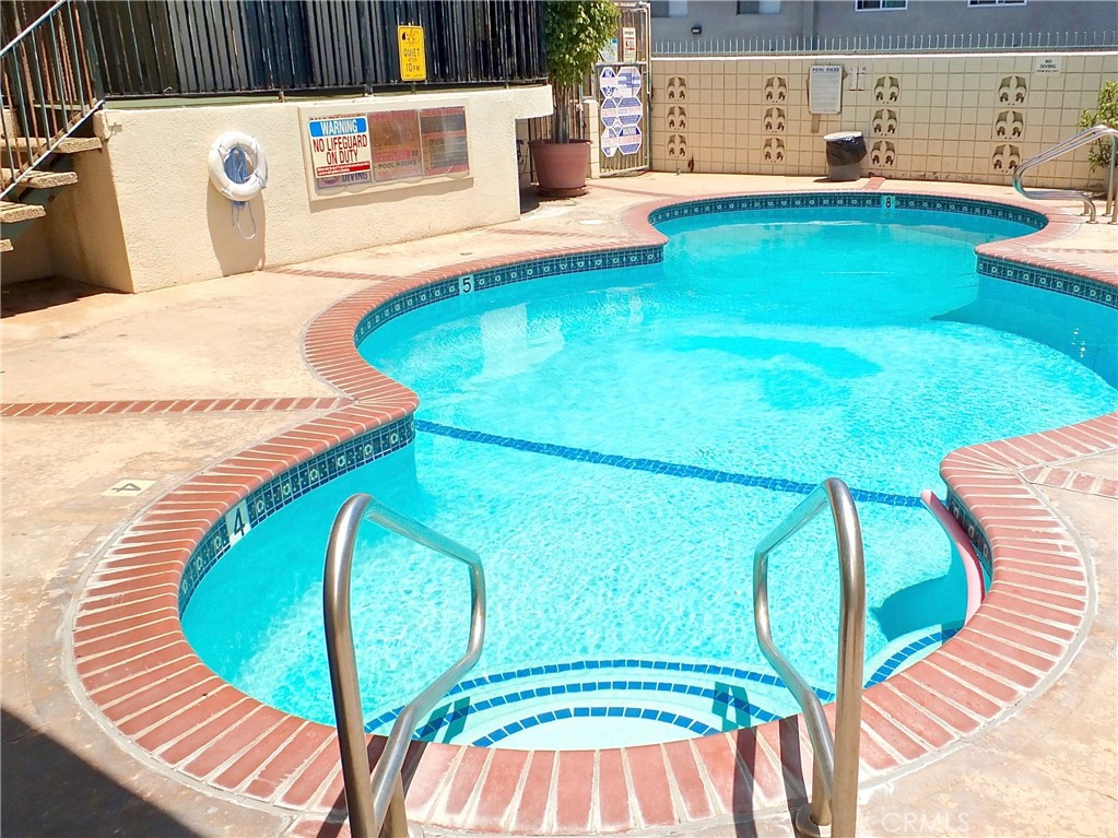 1770 Ximeno Avenue, Unit 314 Long Beach, CA 90815 - Photo 22 of 37 a view of a swimming pool with back yard