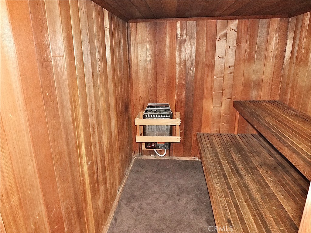 1770 Ximeno Avenue, Unit 314 Long Beach, CA 90815 - Photo 26 of 37 a bedroom with a bed and a chair